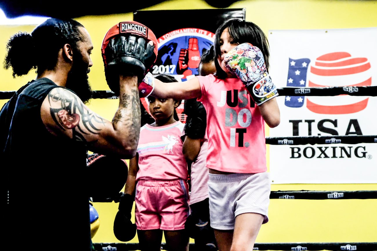 Coach Hector Saez training kids at Bring It Back Boxing in Denver